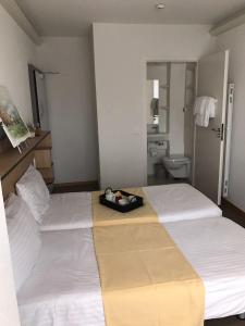 Postel nebo postele na pokoji v ubytování Le Cénacle
