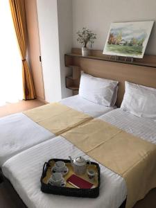 Postel nebo postele na pokoji v ubytování Le Cénacle