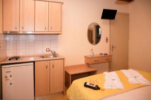 a small kitchen with a bed and a sink at Arion Hotel in Skala Potamias +41 photos