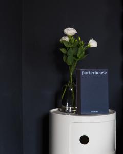 a vase with white flowers on top of a box at The Porterhouse grill & rooms in Oxford
