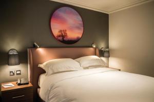 a bedroom with a bed and a round window at Cottons Hotel and Spa in Knutsford