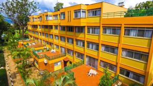 an overhead view of a yellow building at Constellation Apartments in Kampala
