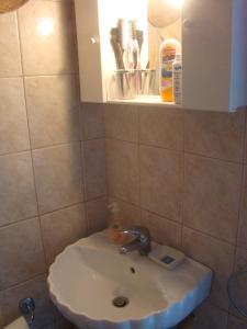 a bathroom with a sink and a cabinet at Superb view House-Sikinos Island-Chorio in Sikinos