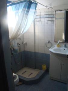 a bathroom with a shower and a toilet and a sink at Superb view House-Sikinos Island-Chorio in Síkinos +30 photos