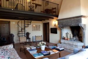 a living room with a table and a fireplace at Parco Ducale Country House in Urbania