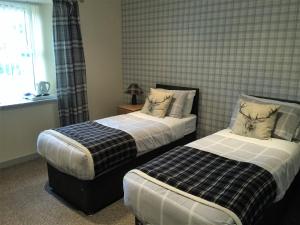 Ein Bett oder Betten in einem Zimmer der Unterkunft Belgrave Arms Hotel