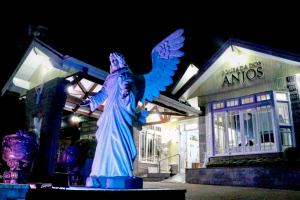 a statue of an angel in front of a building at Pousada dos Anjos in Canela