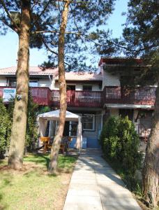 a house with a deck on the side of it at Guesthouse "Nakvynė pas žveją" Vetrungiu Street 298-2 in Nida