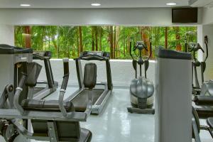 a gym with several tread machines in front of a window at Las Brisas Ixtapa in Ixtapa