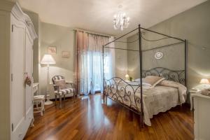 a bedroom with a bed with a metal canopy at Art de vivre in Sorrento +90 photos