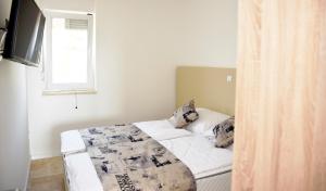 Кровать или кровати в номере Villa M - Your business & holiday apartment in Sibenik