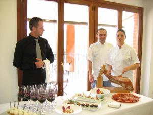 a group of people standing around a table with food at Hotel Conde De Badaran in Badarán
