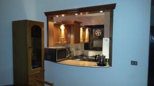 a kitchen with a sink and a microwave at Villa at Karawan Resort in Al Ḩammām