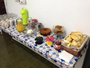 a table with a table cloth with bread on it at Hostel Araucaria in Ribeirão Preto
