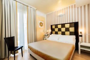 Voodi või voodid majutusasutuse JR Resort Logos Forte dei Marmi toas