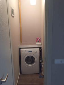 a small bathroom with a washing machine in it at Apartment Lubliana in Tbilisi City +14 photos