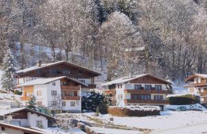 eine Gruppe von Gebäuden im Schnee mit Bäumen in der Unterkunft Haus Astrid-Christoph in Finkenberg