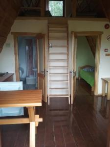 a room with a bed and a wooden bench at Atpūtas komplekss Lakši in Usma +20 photos