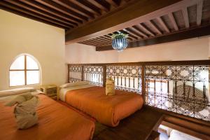 Postel nebo postele na pokoji v ubytování Riad Zanzibar