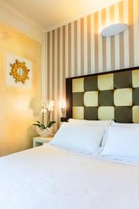 Voodi või voodid majutusasutuse JR Resort Logos Forte dei Marmi toas