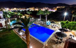 an overhead view of a swimming pool at night at Stelios Gardens in Malia