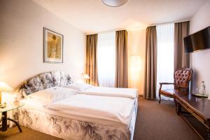 Ένα ή περισσότερα κρεβάτια σε δωμάτιο στο Hotel Wagner Am Marktplatz