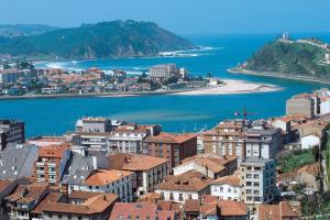 a view of a city and the ocean with buildings at Hotel Covadonga in Ribadesella