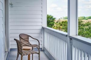 a chair is sitting in front of a window at Shem Creek Inn in Charleston