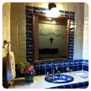 a bathroom with a sink and a mirror at Hotel Santa Clara in San Cristóbal de Las Casas