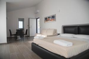a bedroom with a bed and a dining room at Santo Stefano Club in Praia a Mare