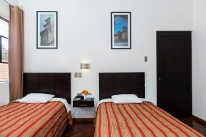 Postel nebo postele na pokoji v ubytování Hostal & Apartments El Triunfo