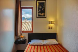 Postel nebo postele na pokoji v ubytování Hostal & Apartments El Triunfo
