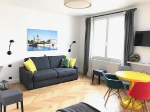 a living room with a couch and a table at Appartement Seine et Marais in Paris