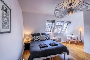 een slaapkamer met een bed en een tafel. bij Appartement Design Hyper Centre Lille - NETFLIX wifi Fibre - Parking in Lille