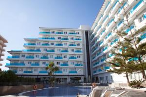 a large building with a pool in front of it at Aparthotel Acuazul in Peñíscola
