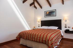 Postel nebo postele na pokoji v ubytování Hostal & Apartments El Triunfo