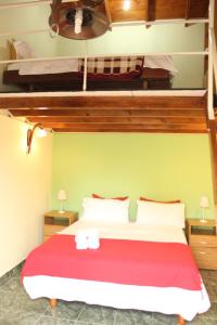 a bedroom with a bed with two bunk beds at Cabaña Escondida in Banfield