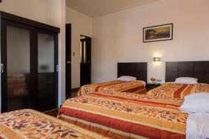 Postel nebo postele na pokoji v ubytování Hostal & Apartments El Triunfo