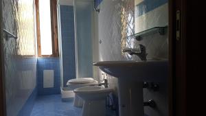 a bathroom with a sink and a toilet at Il Moro della Molpa in Palinuro +25 photos