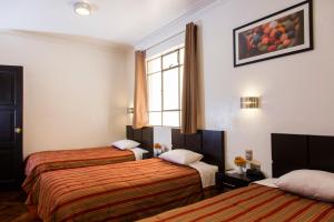 Postel nebo postele na pokoji v ubytování Hostal & Apartments El Triunfo