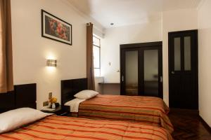 Postel nebo postele na pokoji v ubytování Hostal & Apartments El Triunfo