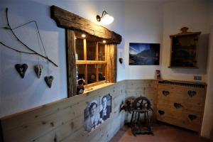 a room with a wooden counter with a window and a chair at B&B Col Da La Vila in Canazei