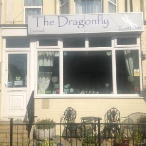 a restaurant with tables and chairs in front of a window at The Dragonfly in Blackpool
