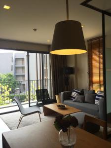 a living room with a couch and a table at Away 23 Estate at Khaoyai in Phayayen