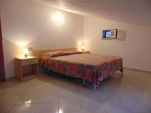 Katil atau katil-katil dalam bilik di Appartamenti Gli Alberi