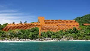a large hotel on a beach with the ocean at Las Brisas Ixtapa in Ixtapa