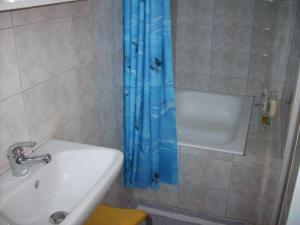 a bathroom with a tub and a sink and a shower at Gouna's Aparts in Xi