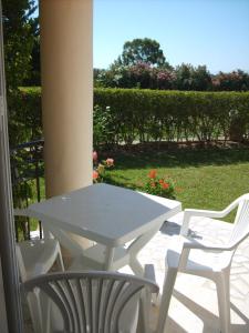 a white table and two chairs on a patio at Gouna's Aparts in Xi