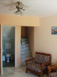a living room with a couch and a staircase at Gouna's Aparts in Xi