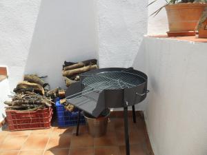 a grill sitting on a floor next to a wall at Casa rural- Casa Liberta in Canet lo Roig